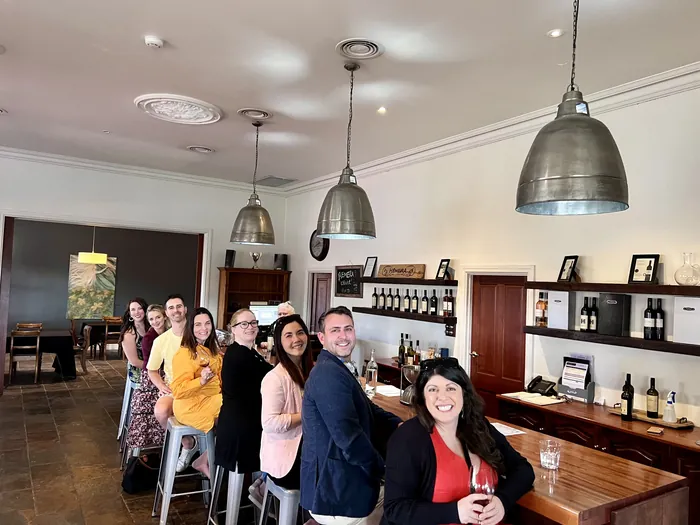 A larger tour group seated together at a Barossa cellar door bar